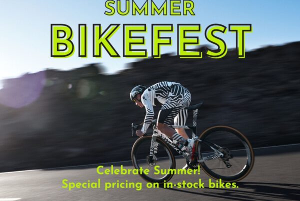 Man riding bike in the mountains. Banner text that says Summer Bikefest